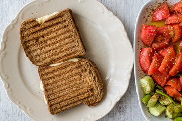 Turkish Toast (tost) with melted cheese, tomatoes and cucumber.