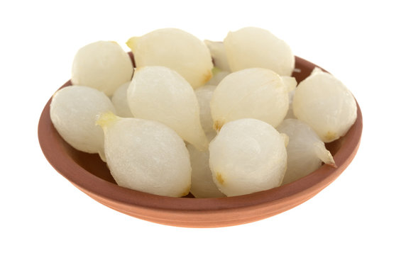 Small bowl with cooked pearl onions isolated on a white background.