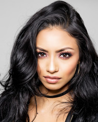 Beautiful exotic young womans face with gorgeous eyes and hair