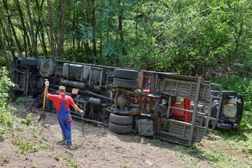 Fototapeta na wymiar Real event, Truck accident, The truck crashed on the road and overturned. Carriage of new cars.