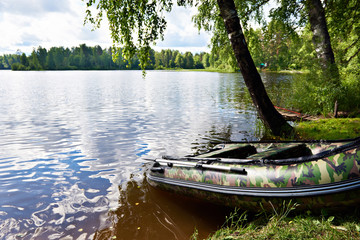 Fishing boat on shore of beautiful lake