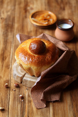 French Brioche Bun on wooden board, on wooden background.