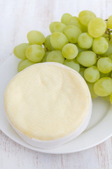 cheese with green grapes on white dish