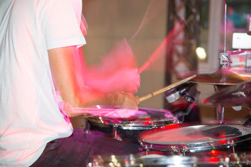 Musician plays drums in a rock band