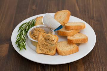 toasts with fish pate on white plate