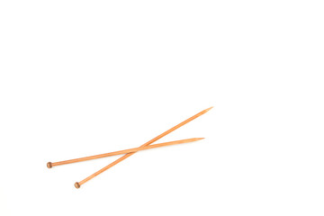 A pair of wooden knitting needles on white background.