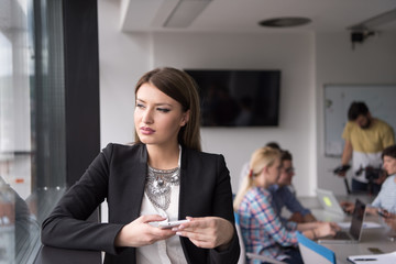 Business Girl Standing In A Modern Building Near The Window With Phone