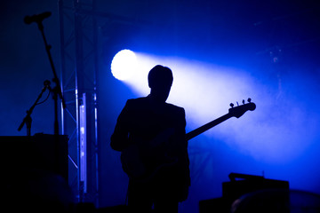 Silhouette of a guitar player on the stage