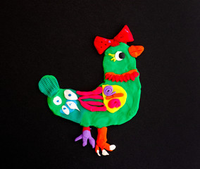 Green bird with red bow made out of play clay