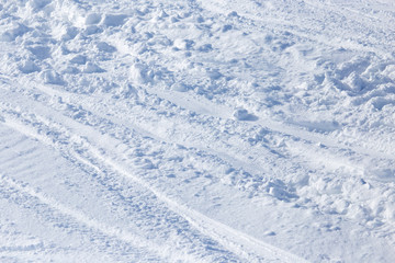 Fototapeta na wymiar Traces of skis on snow as background