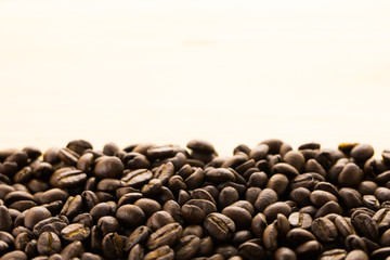 Coffee beans on wood background