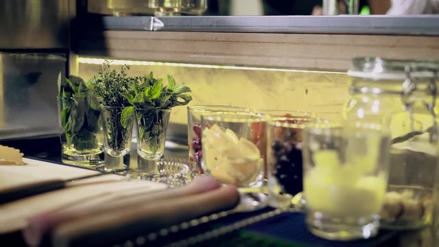 close up shot of the ingredients that stand on the bar counter, spices, berries and other additives are in a glass bowl