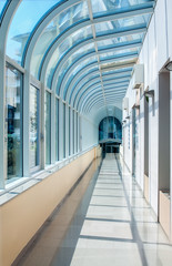 The corridor in the form of a semicircular tunnel with transparent glass walls.