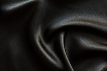 black satin  fabric with large folds,  abstract background