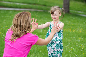 Mother and daughter playing in park