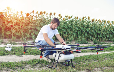 Preparing a drone for take off despite the sunset. Octocopter flights outdoors, aerial imagery and tech hobby, recreation concept.