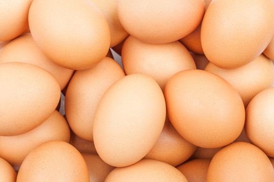 Background with fresh brown chicken eggs close-up