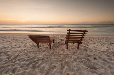 Fototapeta na wymiar Relaxing chair on the beach during sunset