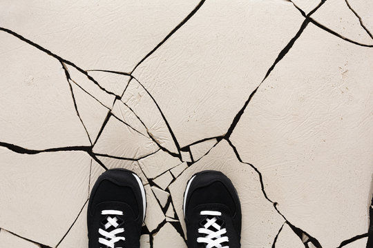 Black shoes on cracked floor copy space