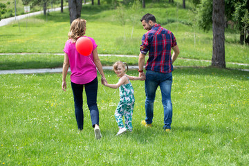 Young parents and his daughter,enjoy in park