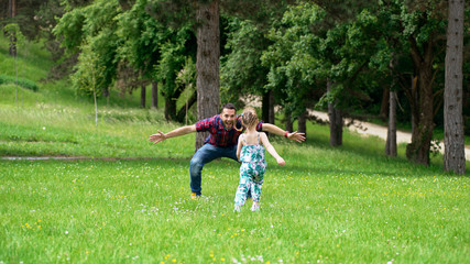 Fototapeta premium Father and daughter playing in park