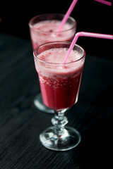Fresh cool smoothie in a glass with a stem. Delicious and healthy Breakfast. Of cherries and strawberries