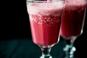 Fresh cool smoothie in a glass with a stem. Delicious and healthy Breakfast. Of cherries and strawberries