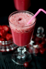 Fresh cool smoothie in a glass with a stem. Delicious and healthy Breakfast. Of cherries and strawberries