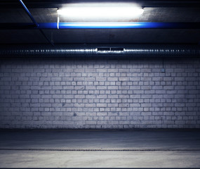 Urban underground background. Brick wall under the lamp light in the dark