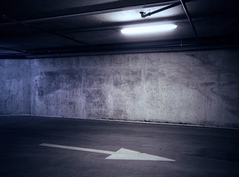 Urban underground background. Concrete wall under the lamp light in the dark.