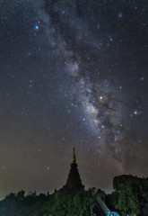 Naklejka premium milky way in starry night with pagoda on top of inthanon national park mountain at Chiang Mai, Thailand
