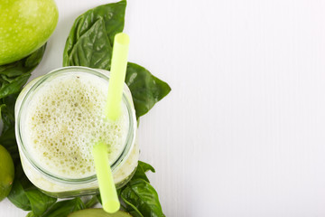 Green smoothie of kiwi,banana,Apple on a white wooden background