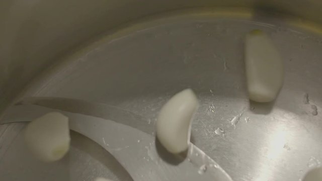 peeled garlic gloves poured into food chooper. super slow