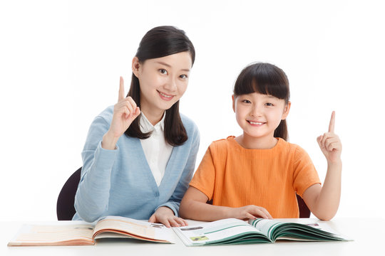 Female teacher helping school girl study