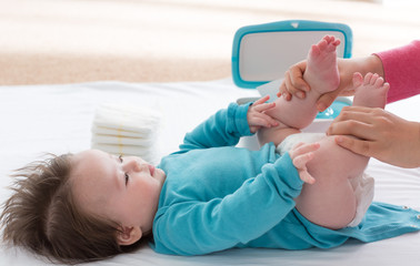 Little baby boy being cared for by his mother
