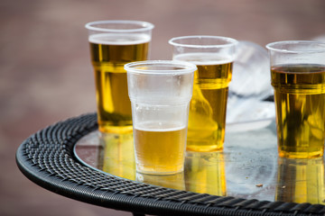 Beer in a plastic glass on the table