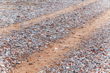 Road is strewn with rubble from pieces of concrete and brick