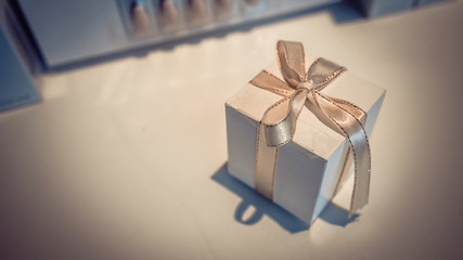 White Gift Box And Gold Bow Tie