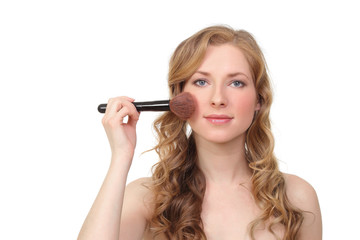 woman applied blush on her cheeks