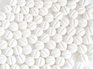 Fototapeta na wymiar Pile of white pills on white background