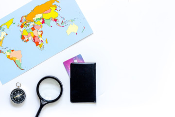 Planning trip. World map, compass and bank card on white background top view copyspace