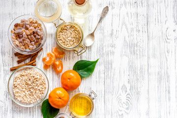 Preparing healthy breakfast with oranges on light wooden table top view copyspace