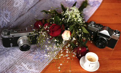 vintage camera near a bouquet of flowers and candles micro stock photo