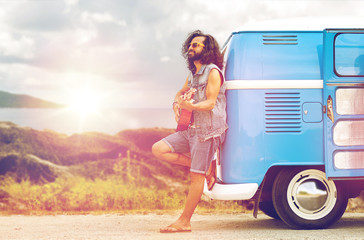 hippie man playing guitar at minivan car on island