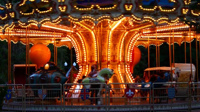 The French carousel is spinning and glowing with lights