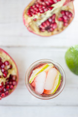 Top view of pomegranate lemonade with lime and ice