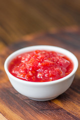 Indian chutney or mexican salsa in white ceramic bowl.