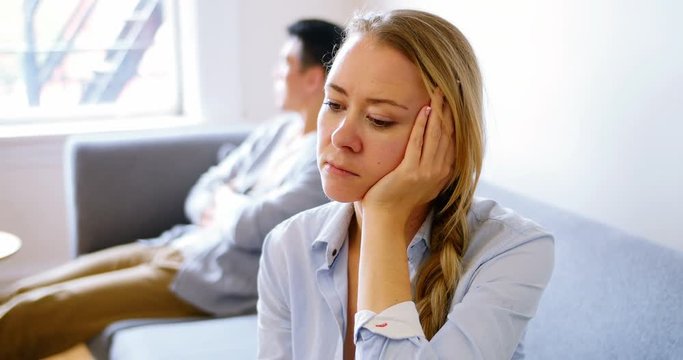 Man and woman upset with each other in living room