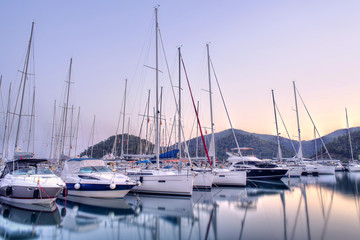 Obraz na płótnie Canvas Yachts parking in harbor at sunset, Harbor yacht club in Gocek, Turkey