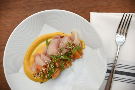 Raw fish and assorted vegetable served on plate